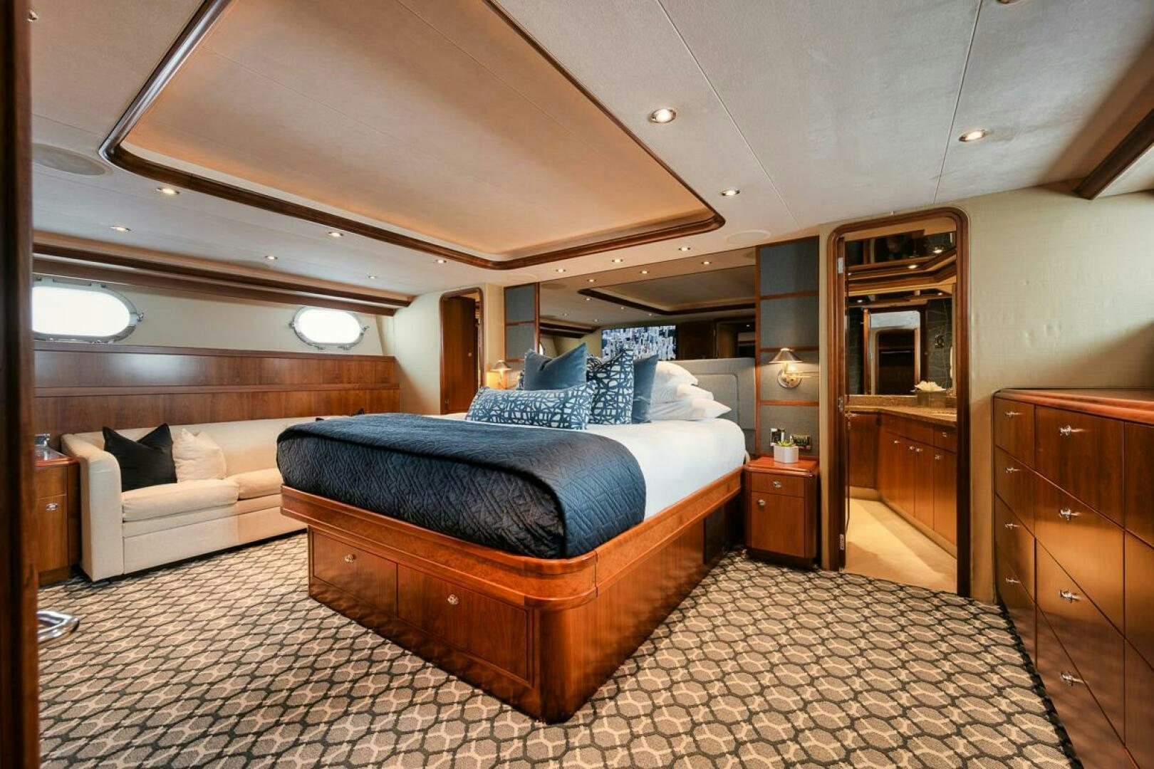 a bedroom with a bed and a couch aboard NATURAL 9 X KALEEN Yacht for Sale