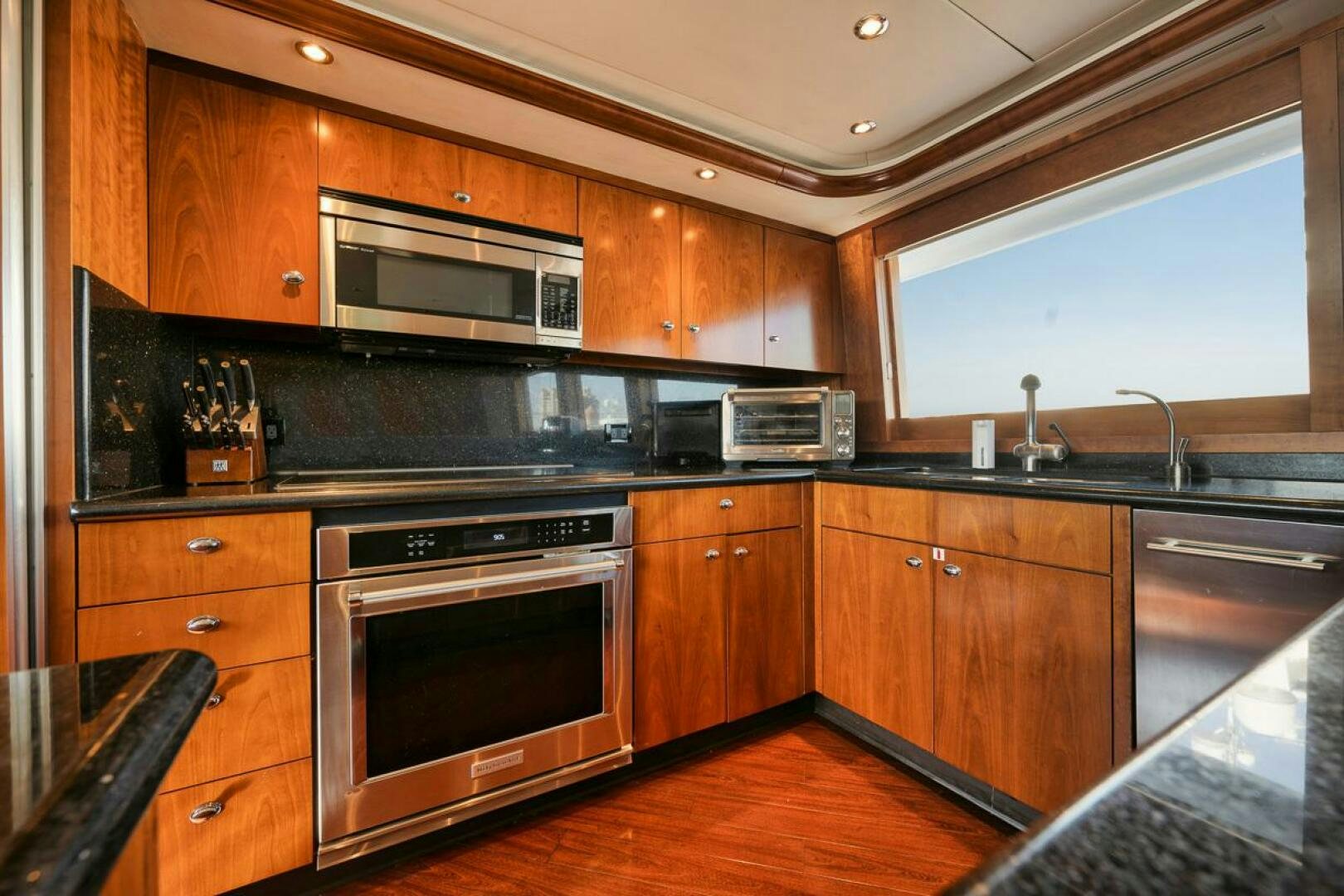 a kitchen with wooden cabinets aboard NATURAL 9 X KALEEN Yacht for Sale