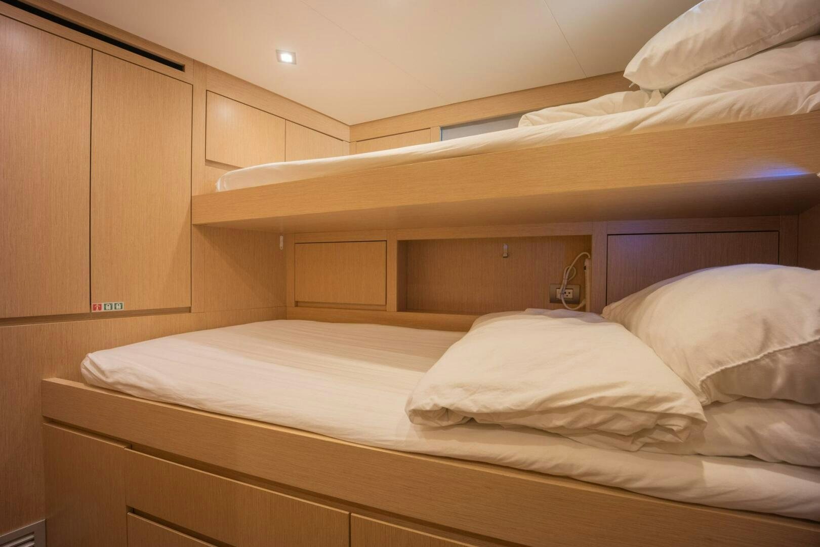 a bed with white sheets aboard PHOENIX Yacht for Sale