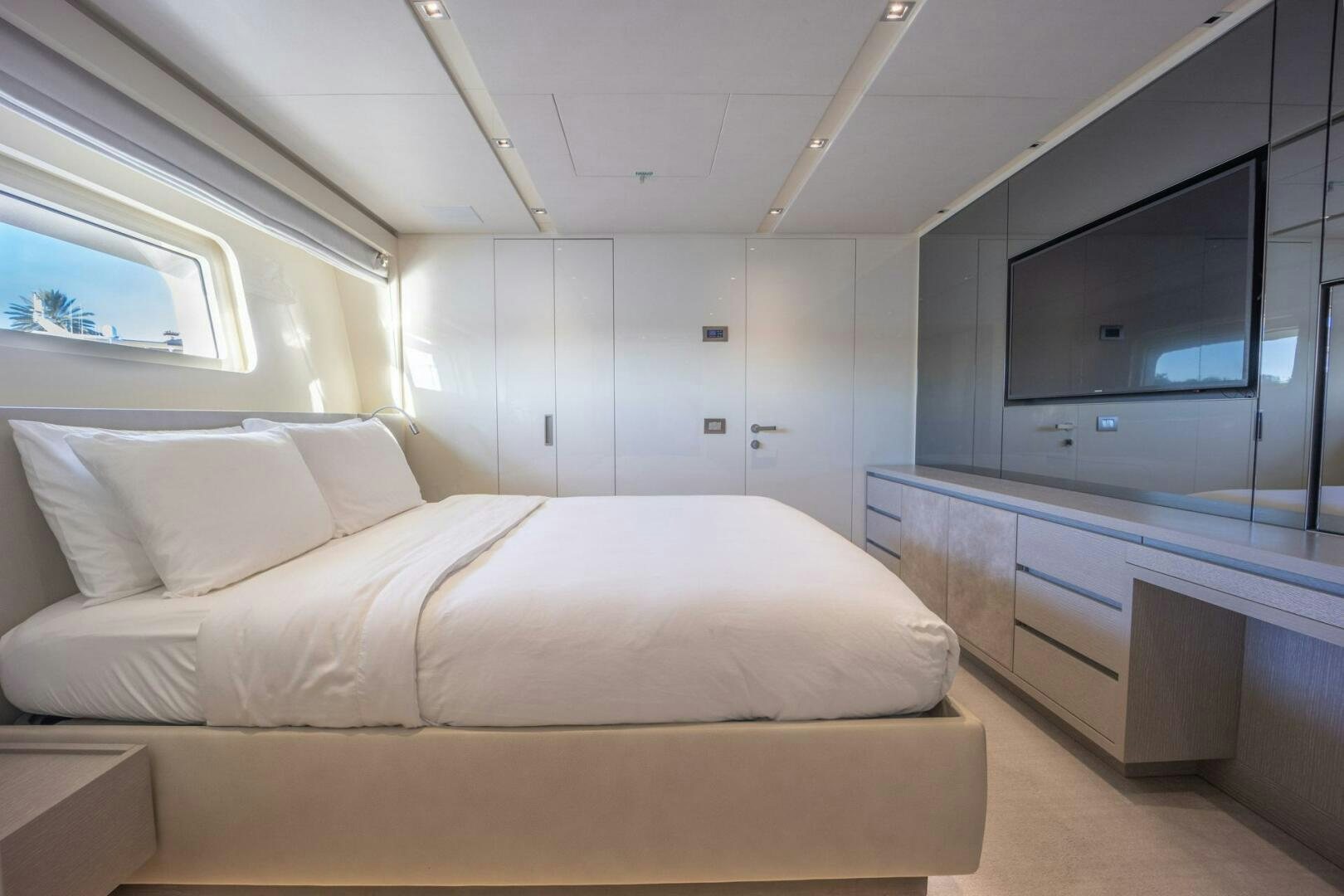 a room with a bed and a tv aboard PHOENIX Yacht for Sale