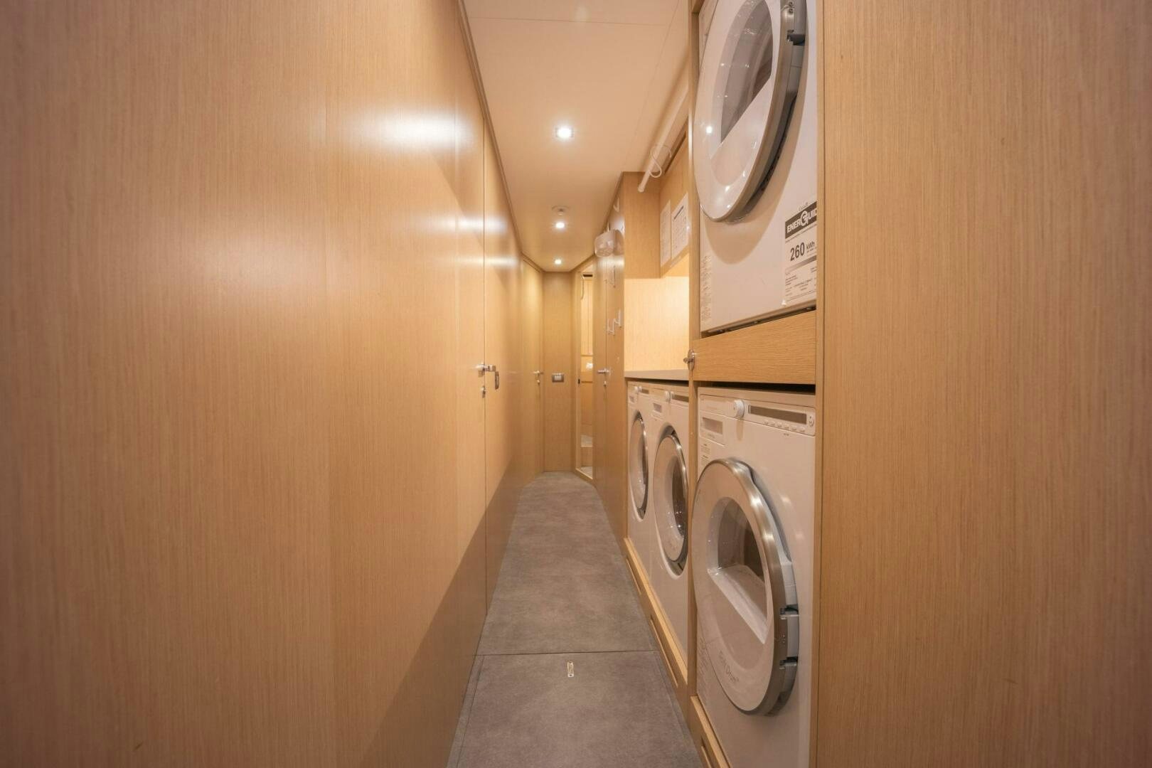 a hallway with a washing machine aboard PHOENIX Yacht for Sale