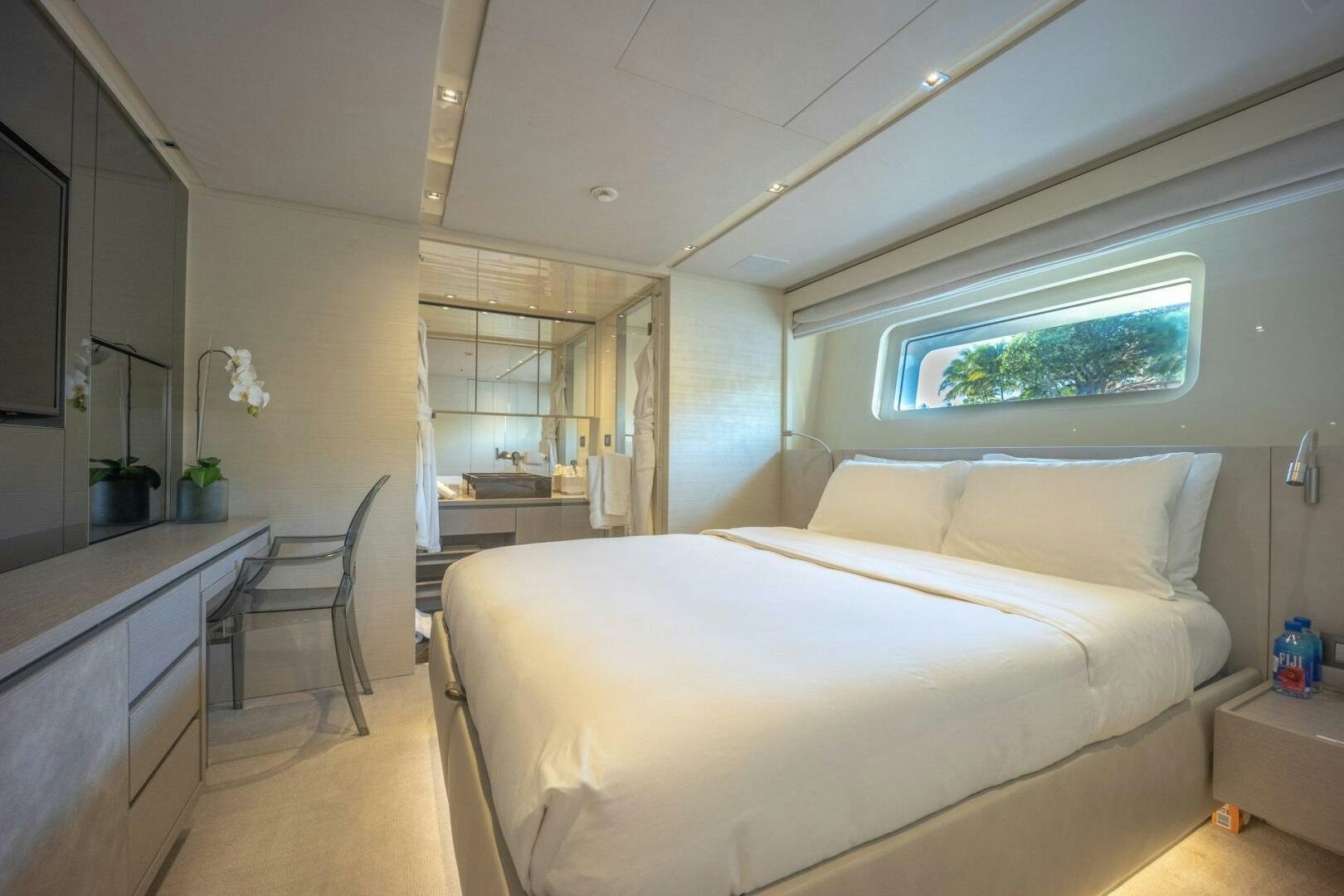 a bedroom with a bed and a desk aboard PHOENIX Yacht for Sale
