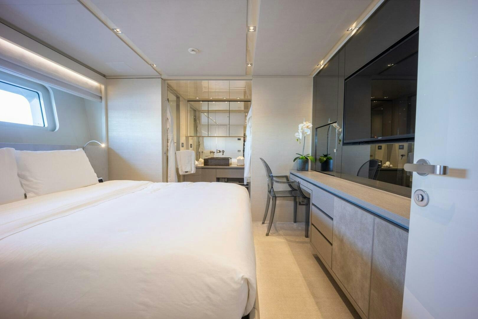 a room with a bed and a desk aboard PHOENIX Yacht for Sale