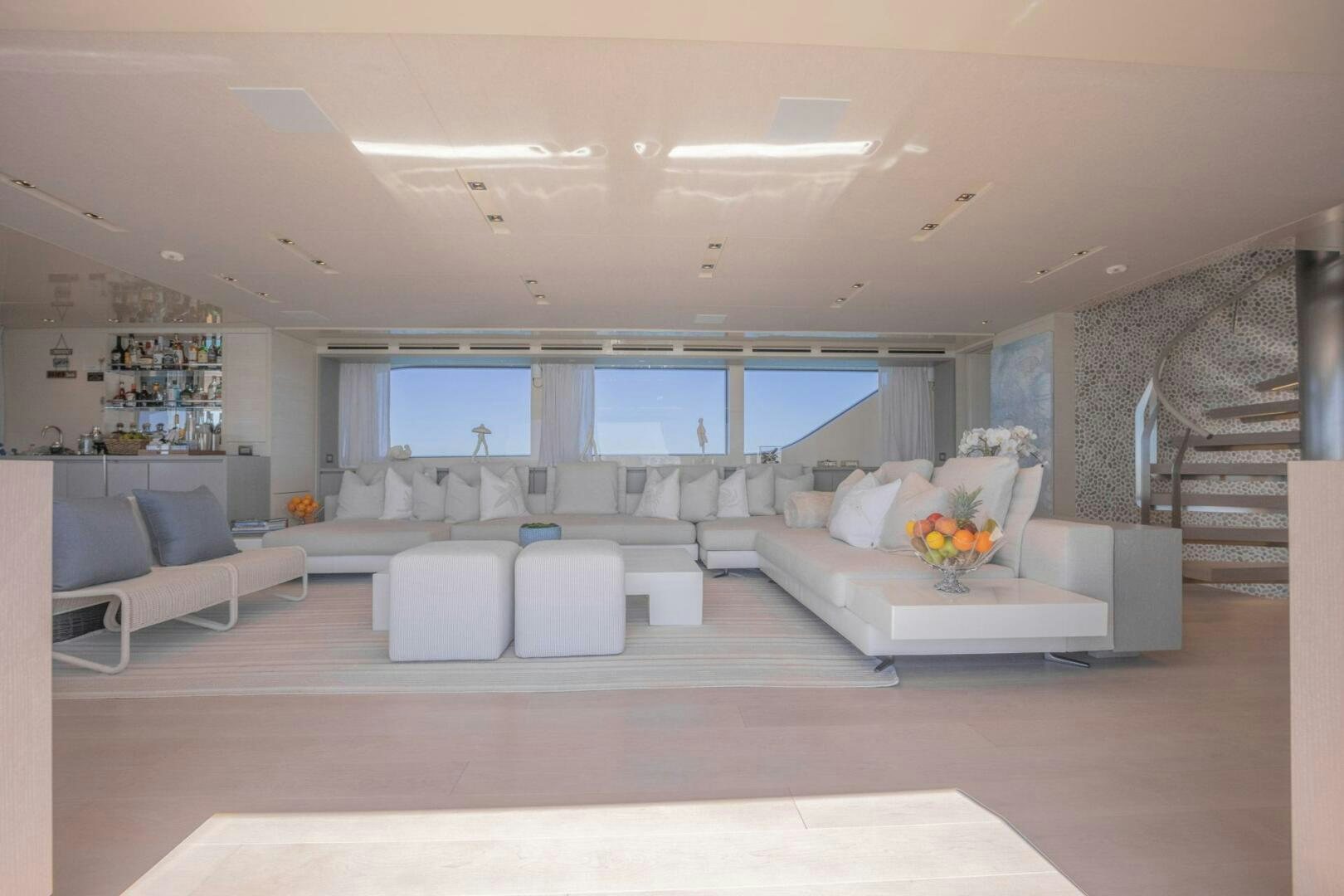 a large living room with white furniture aboard PHOENIX Yacht for Sale