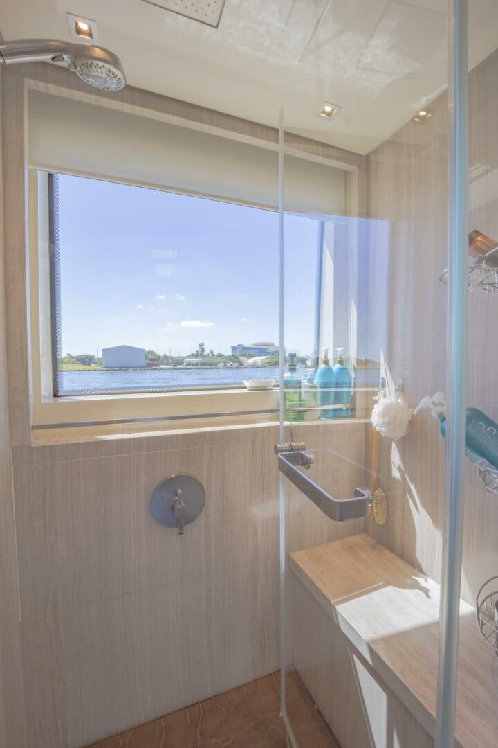 a shower with a glass door aboard PHOENIX Yacht for Sale