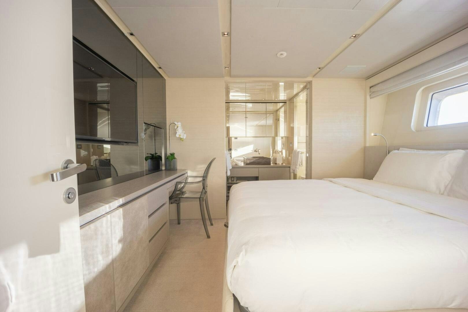 a bedroom with a bed and a desk aboard PHOENIX Yacht for Sale