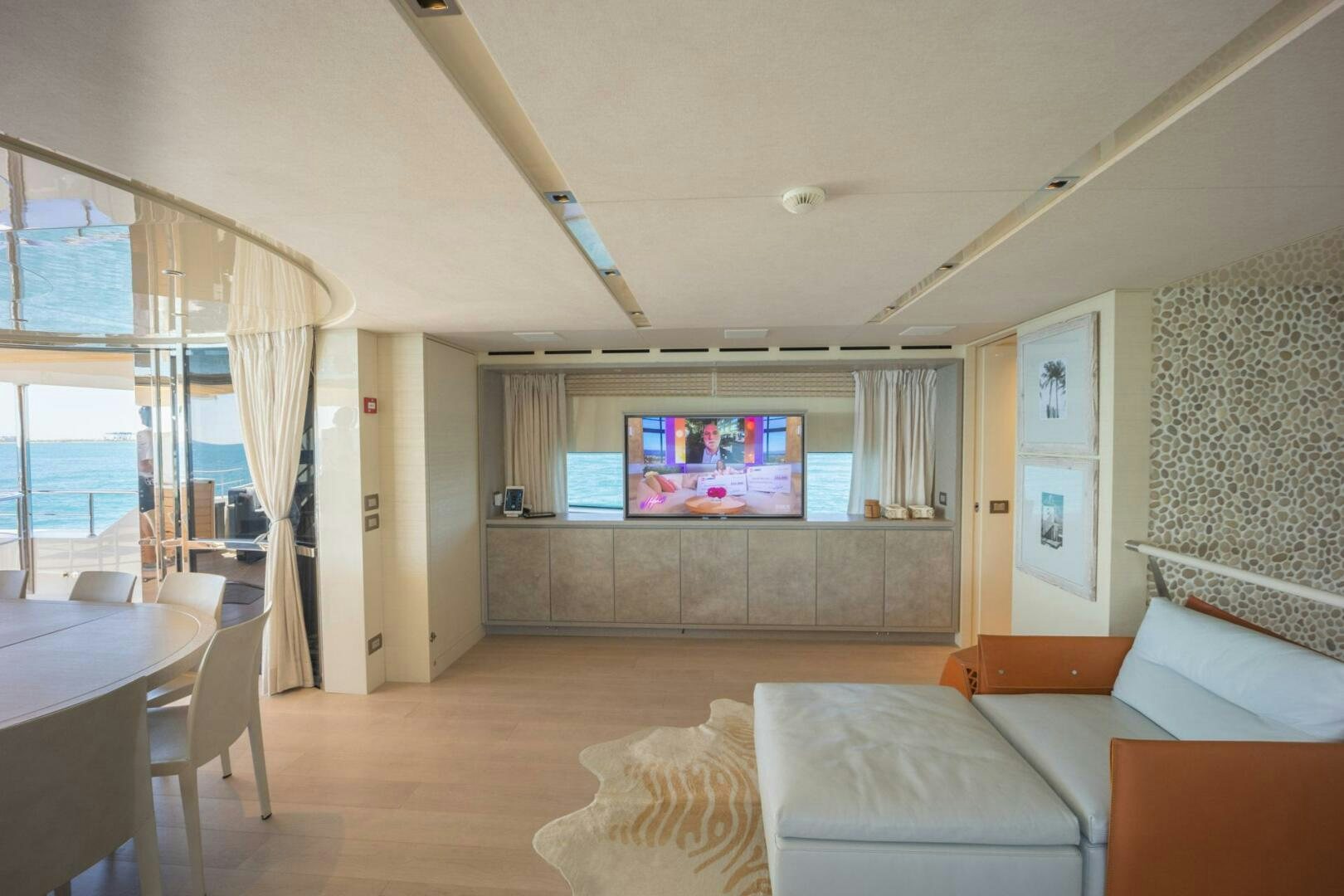 a living room with a large screen aboard PHOENIX Yacht for Sale