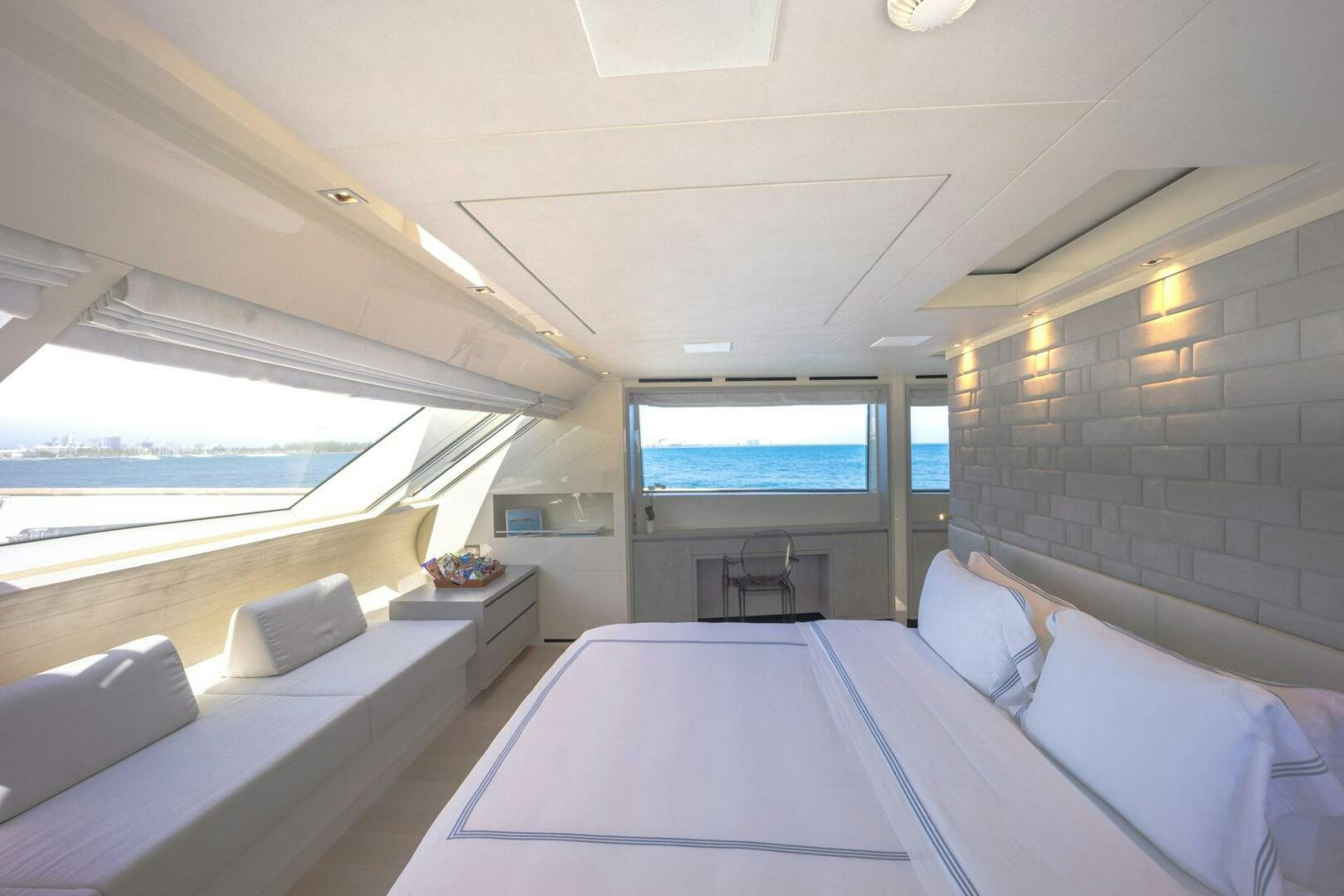 a room with a bed and a large window aboard PHOENIX Yacht for Sale
