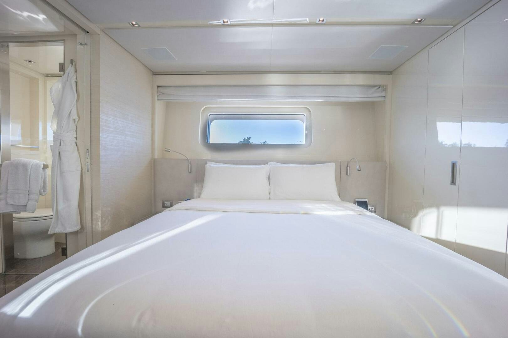 a white bed with white sheets aboard PHOENIX Yacht for Sale