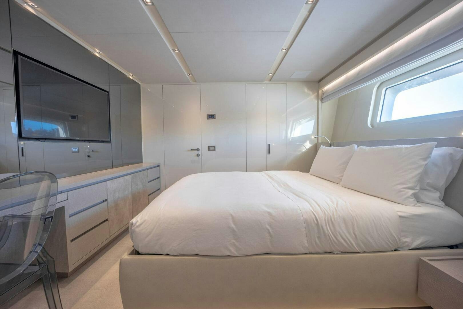 a room with a bed and a window aboard PHOENIX Yacht for Sale
