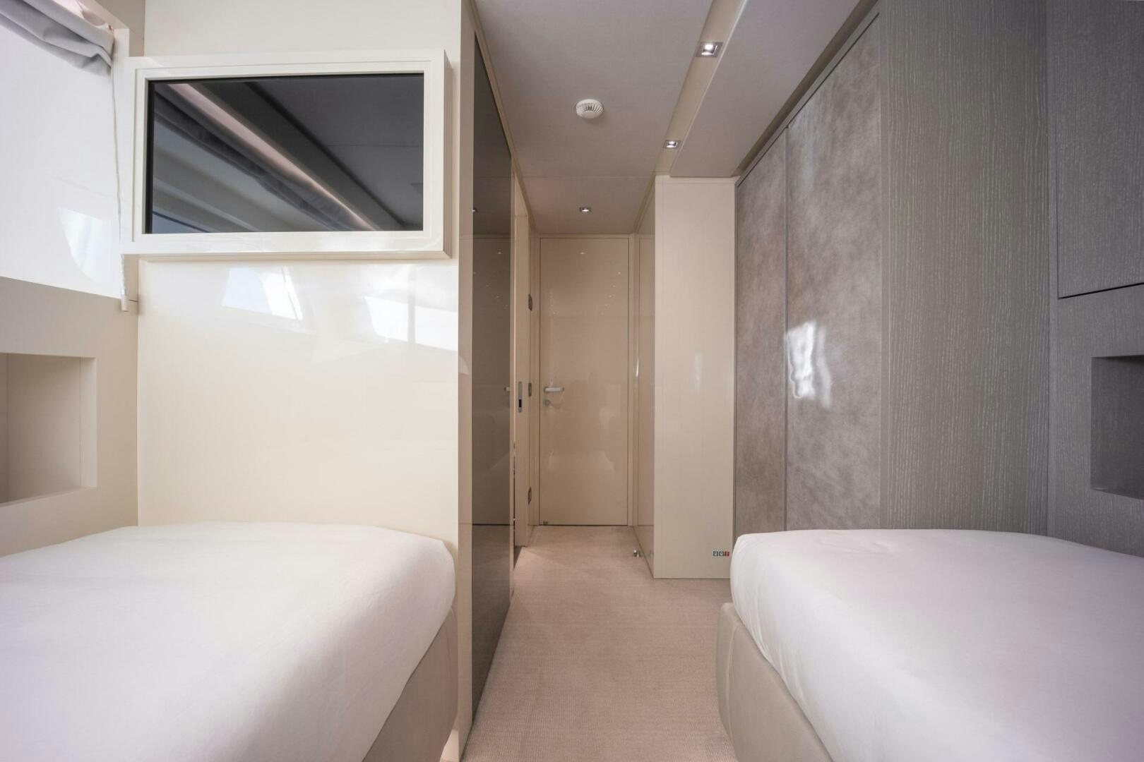 a room with a bed and a television aboard PHOENIX Yacht for Sale