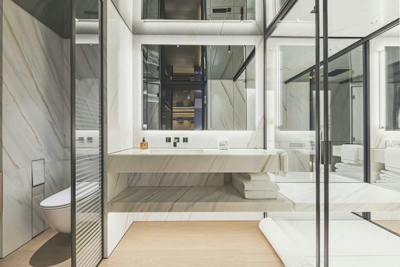 a bathroom with glass walls aboard CONRAD C144S HULL 4 Yacht for Sale