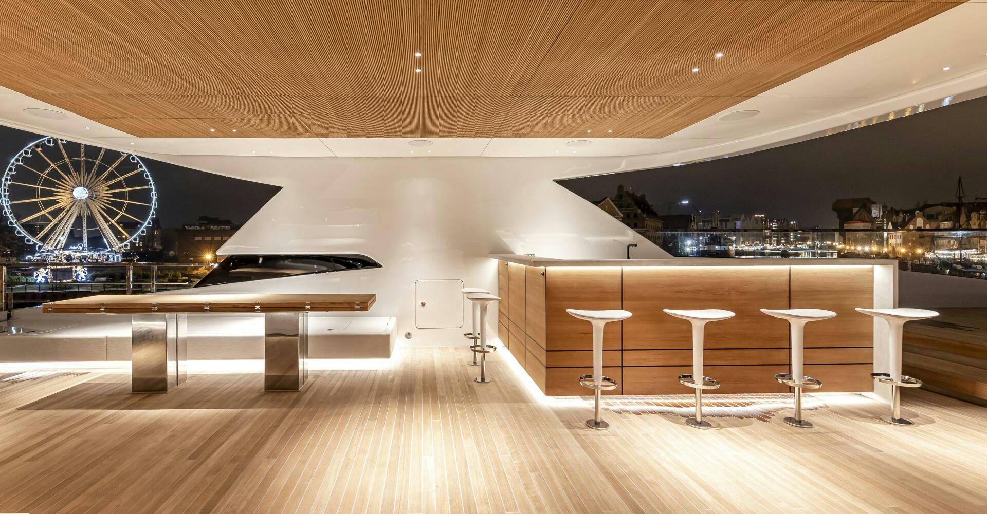 a room with tables and stools aboard CONRAD C144S HULL 4 Yacht for Sale