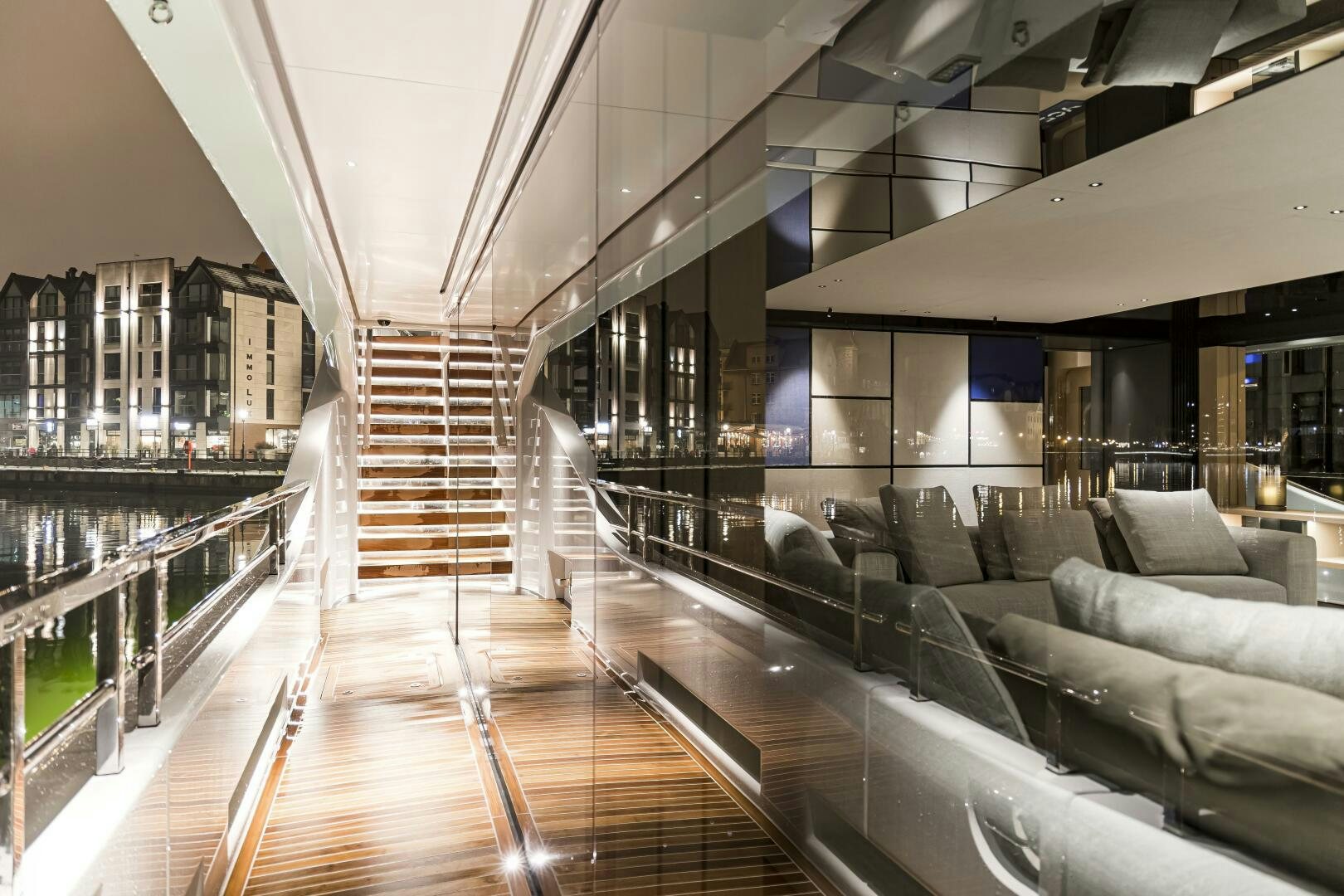 a large room with couches and a staircase aboard CONRAD C144S HULL 4 Yacht for Sale