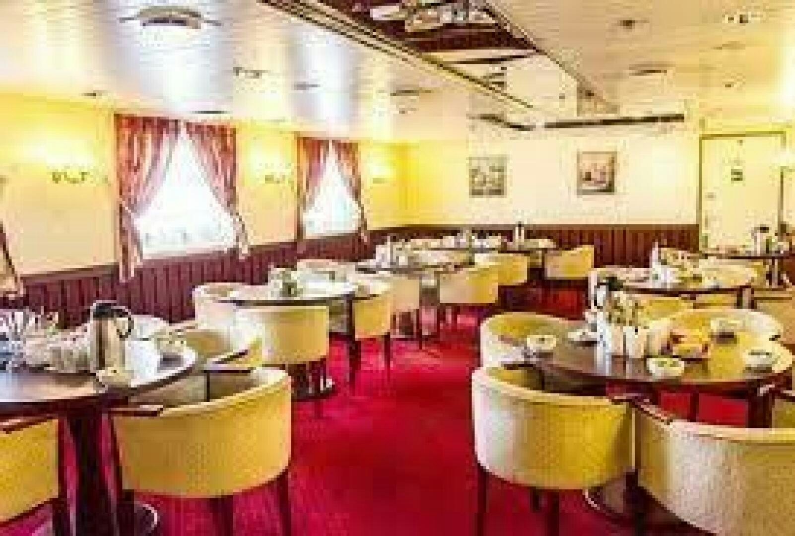 a room full of tables and chairs aboard KAUNAS Yacht for Sale