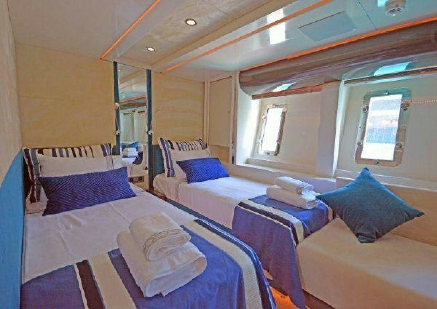 a room with beds and a window aboard VETRO Yacht for Sale