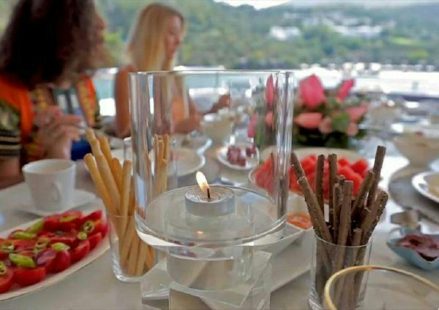 a table with many small dishes of food on it aboard VETRO Yacht for Sale