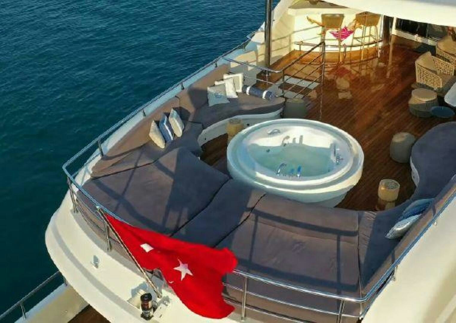 a swimming pool with a deck and chairs around it aboard VETRO Yacht for Sale