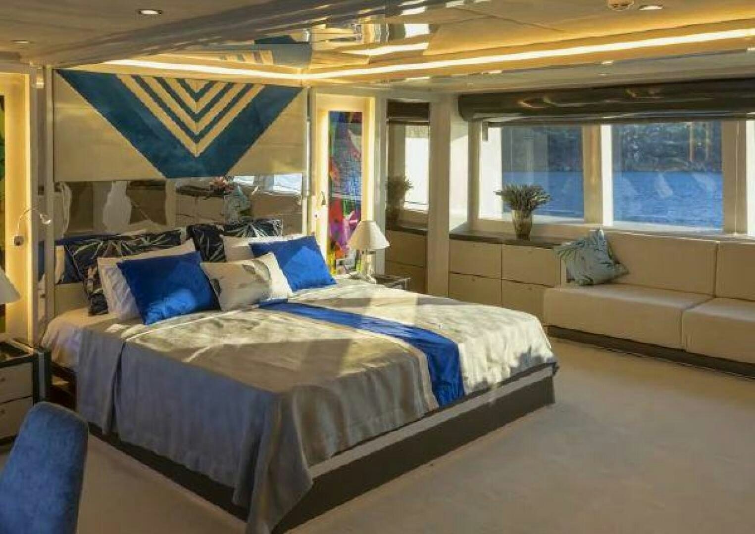 a room with a bed and a couch aboard VETRO Yacht for Sale