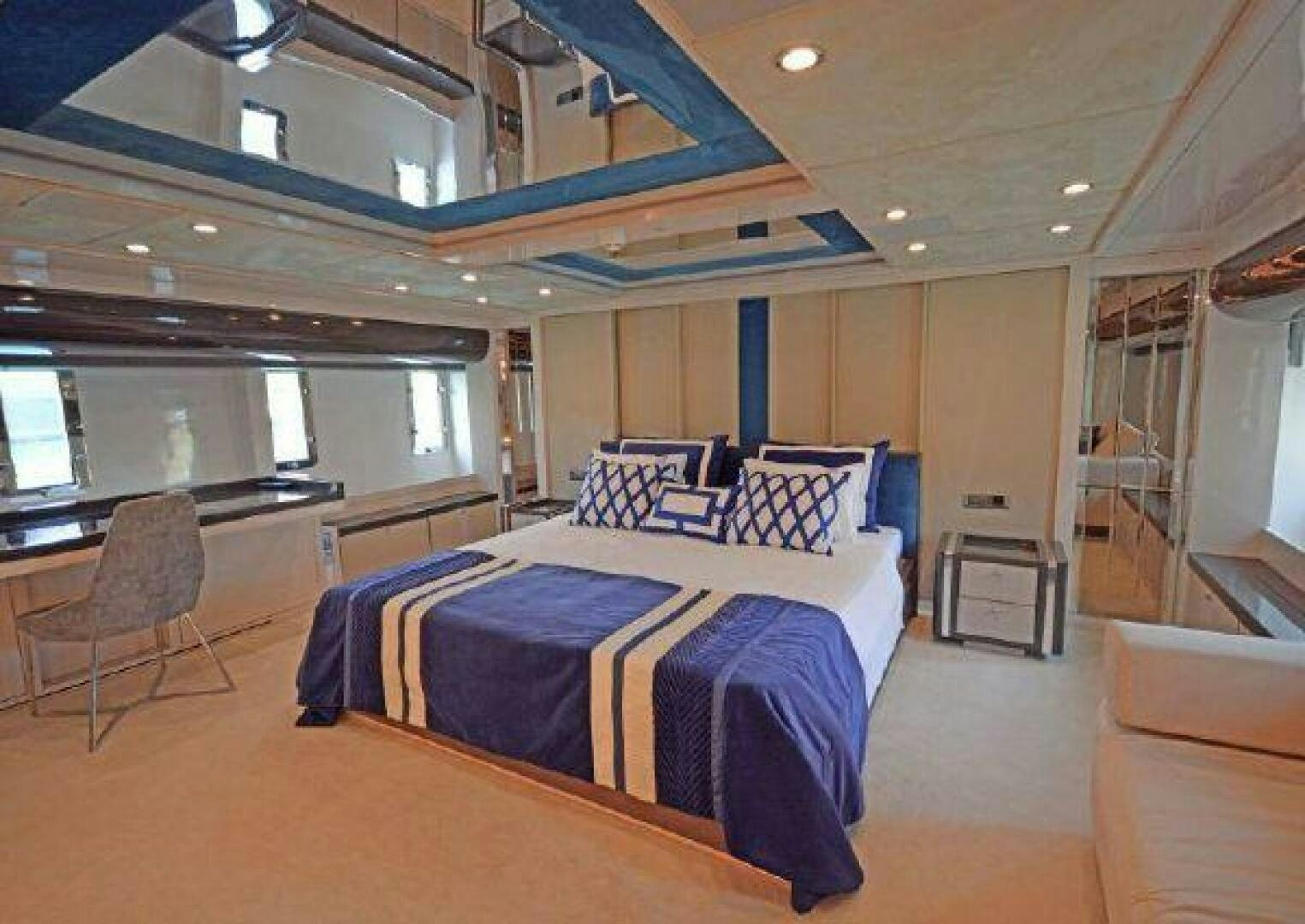 a bedroom with a bed and a couch aboard VETRO Yacht for Sale