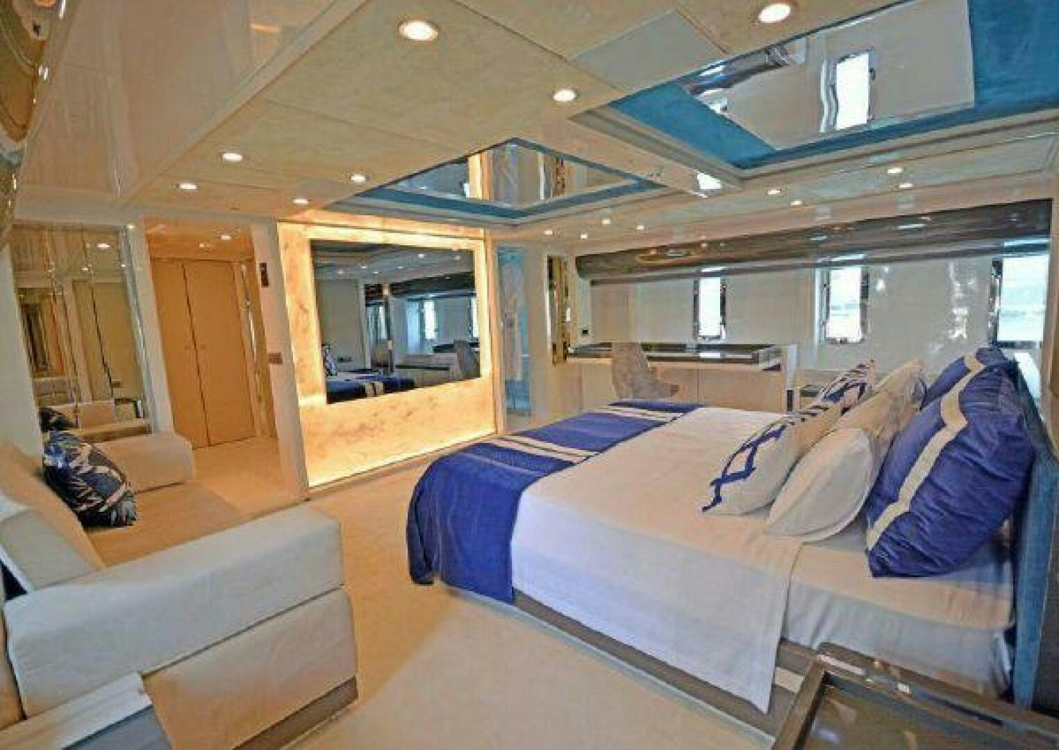 a room with a bed and a couch aboard VETRO Yacht for Sale