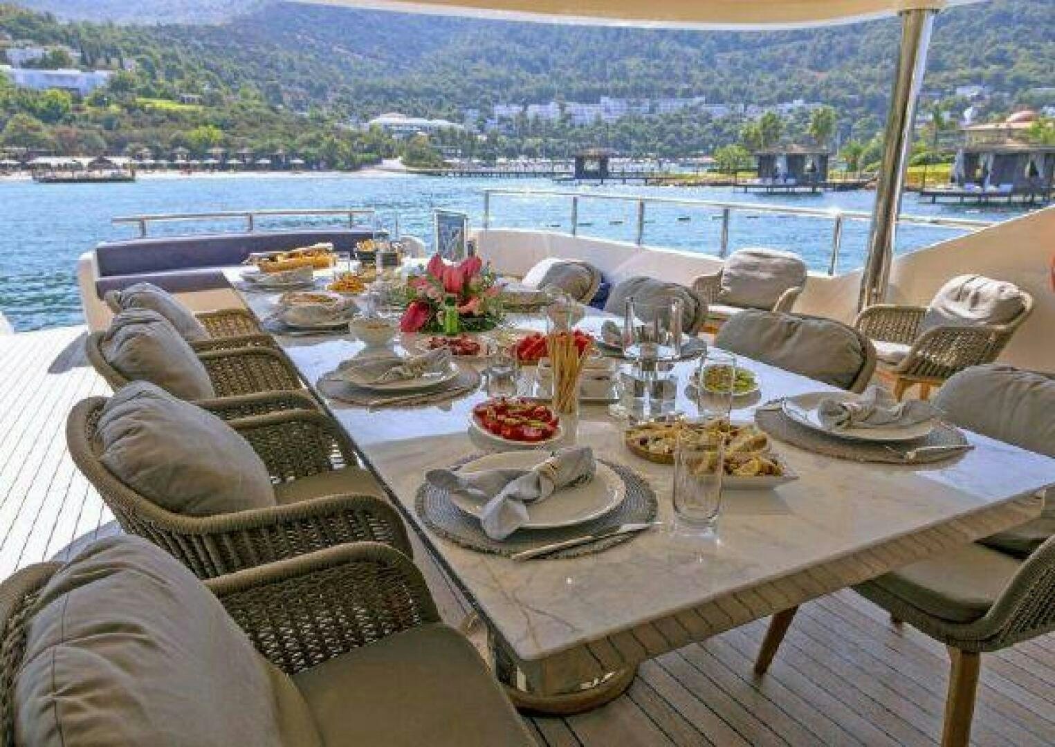 a table with food and drinks on it aboard VETRO Yacht for Sale