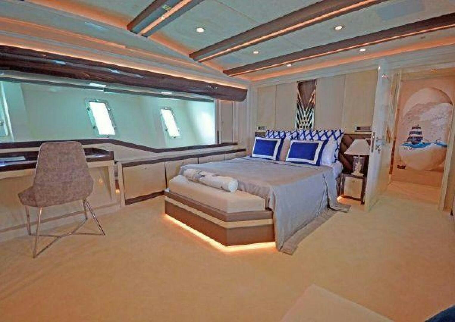 a bedroom with a bed and a desk aboard VETRO Yacht for Sale