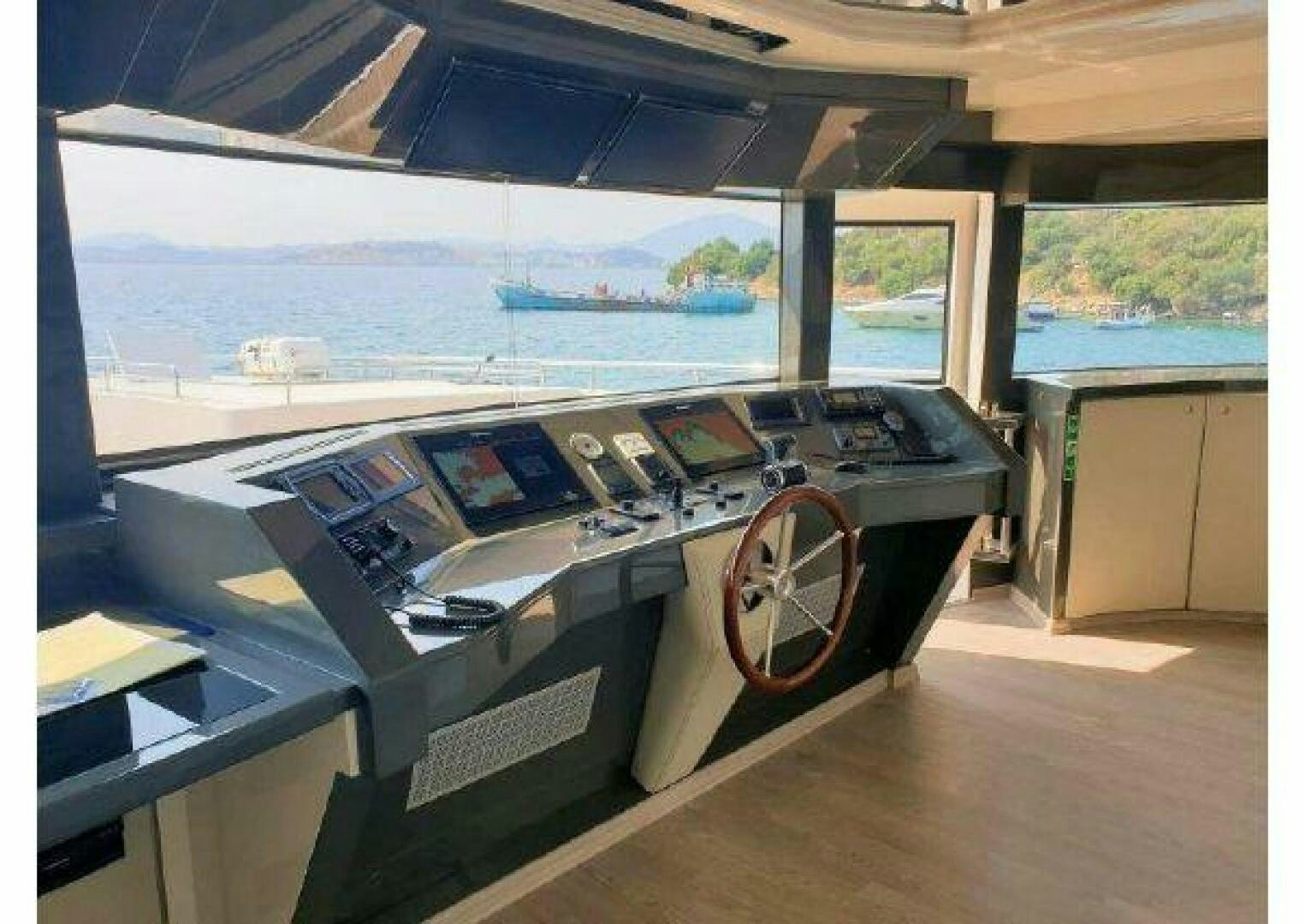 a room with a large window and a large table with chairs and a large window aboard VETRO Yacht for Sale