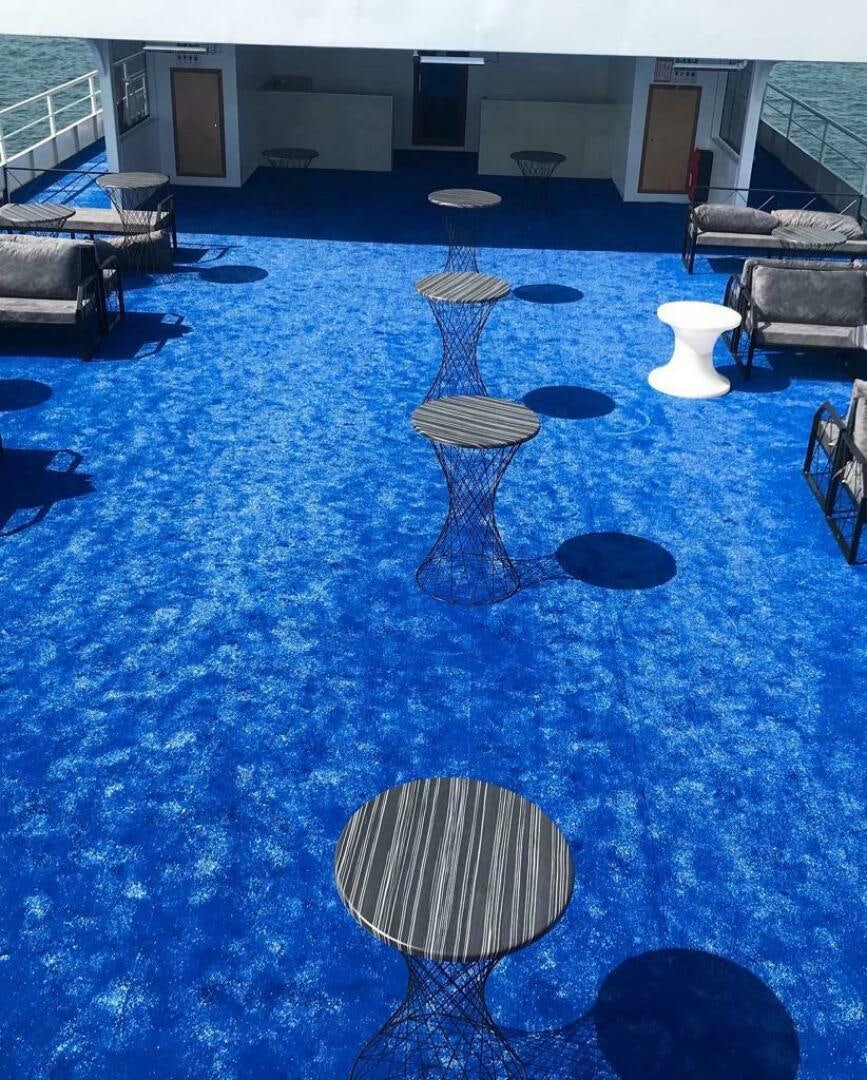a blue pool with chairs and tables aboard DURU LIFE 1 Yacht for Sale