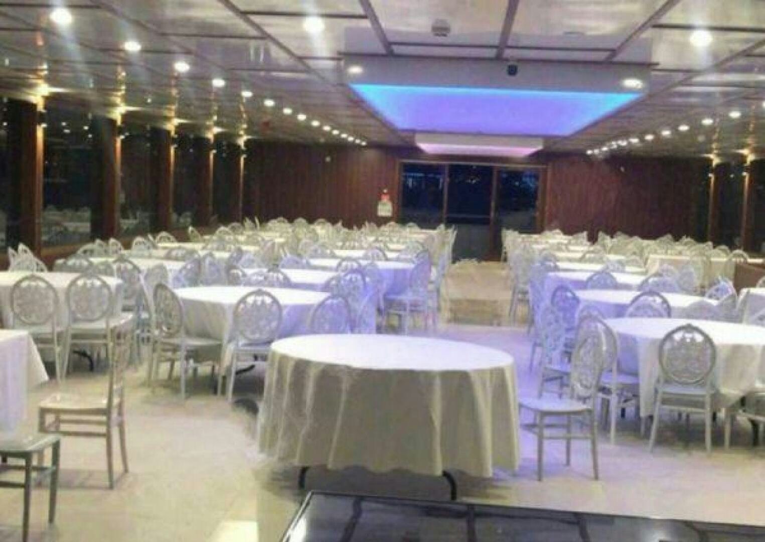 a room with tables and chairs aboard DURU LIFE 1 Yacht for Sale