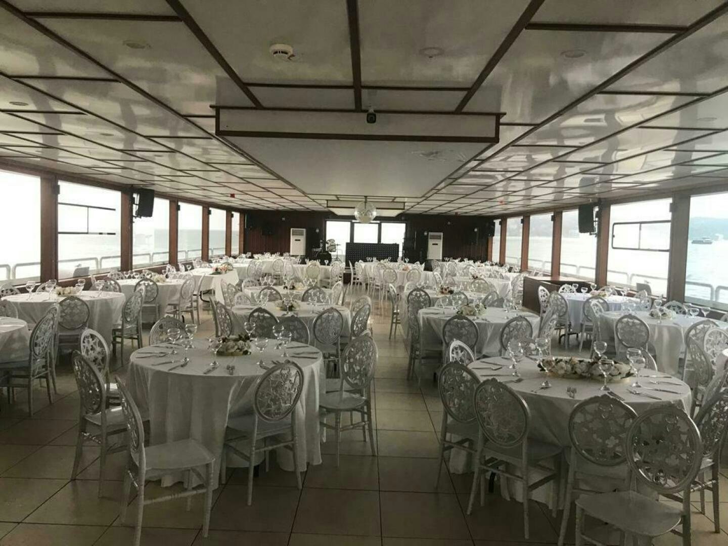 a room with tables and chairs aboard DURU LIFE 1 Yacht for Sale