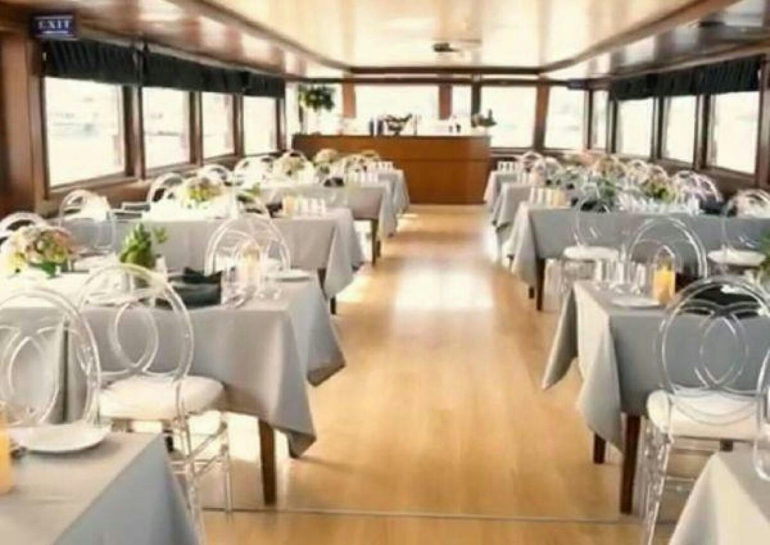 a room with tables and chairs aboard BOSPHORUS PRINCESS Yacht for Sale