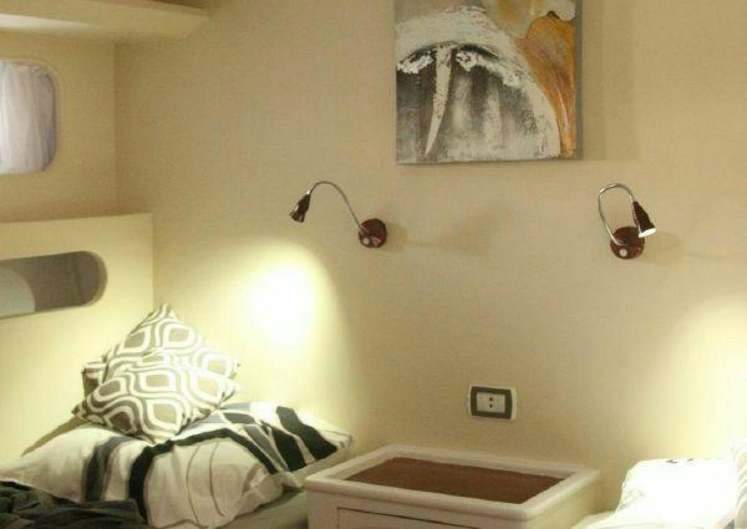 a room with a lamp and a bed aboard RED SEA QUEEN Yacht for Sale