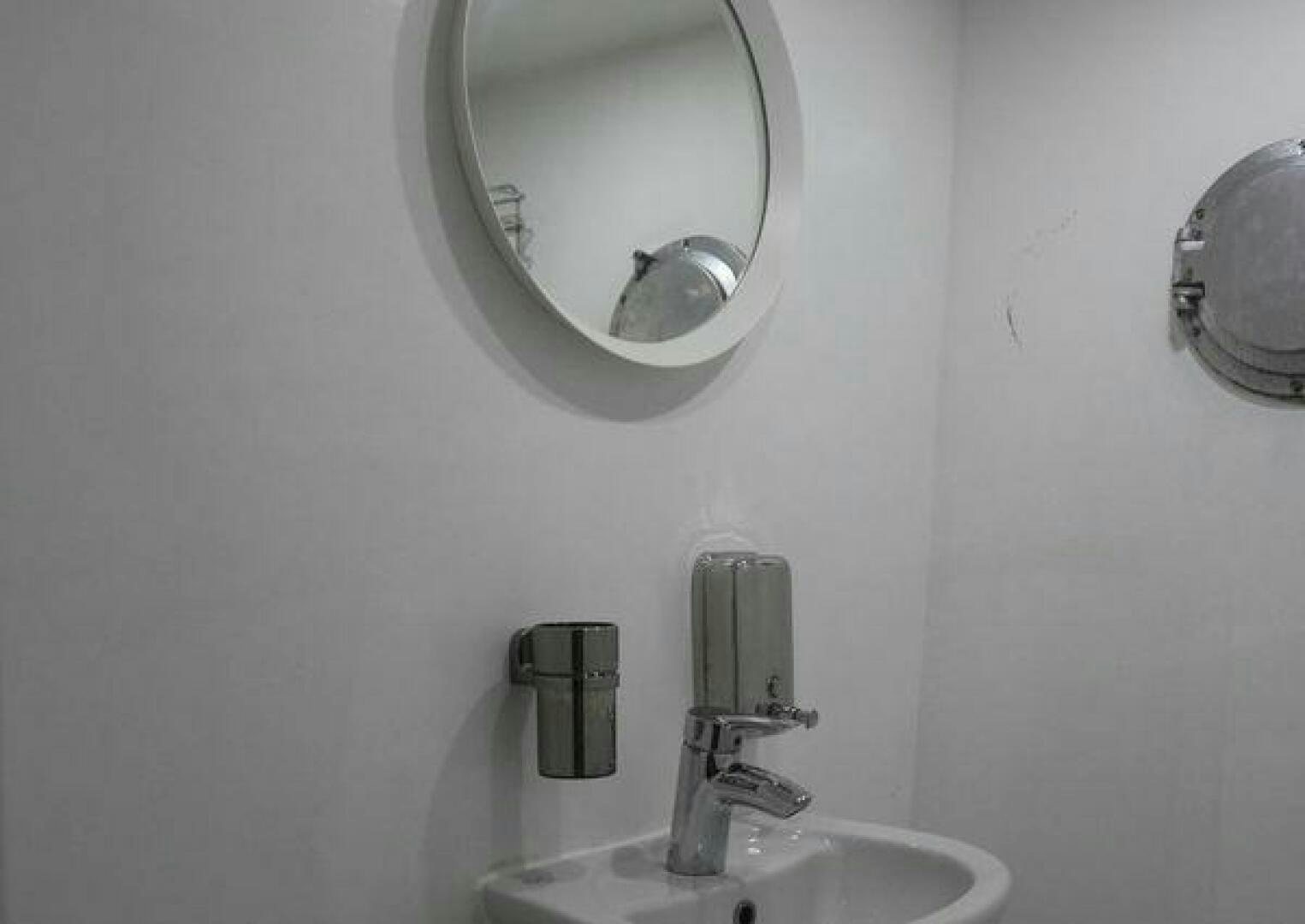 a bathroom with a mirror and a sink aboard RED SEA QUEEN Yacht for Sale