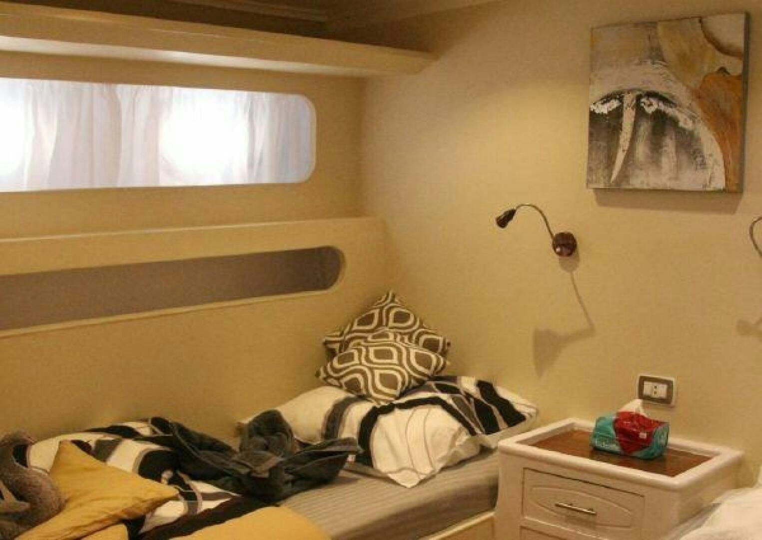 a messy bedroom with a lamp aboard RED SEA QUEEN Yacht for Sale