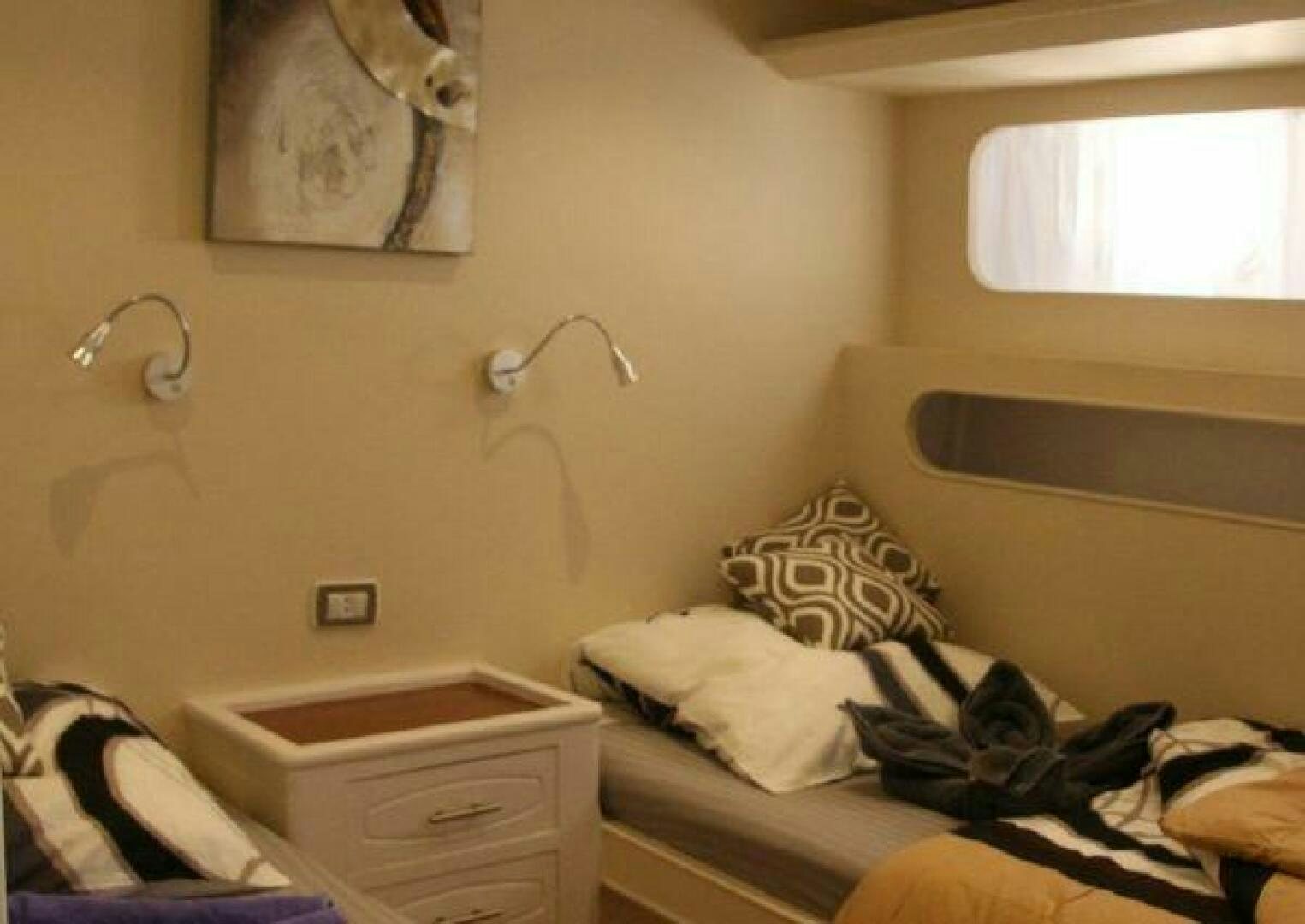 a small bedroom with a bed aboard RED SEA QUEEN Yacht for Sale