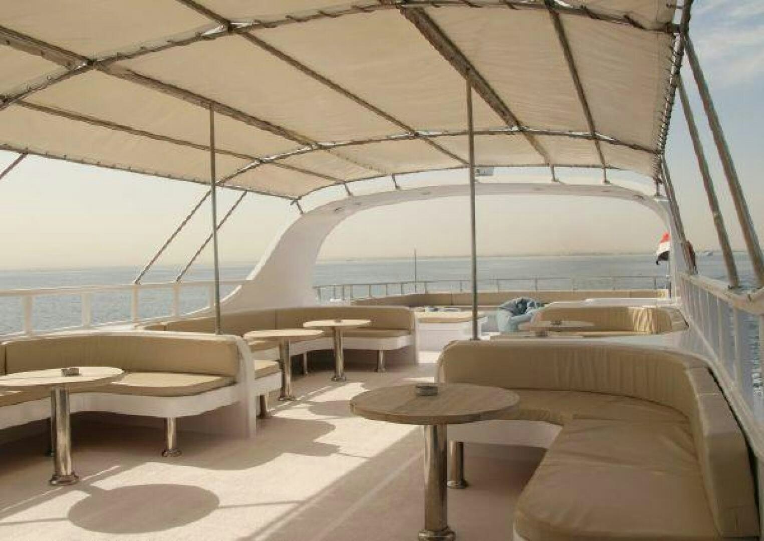a room with a table and chairs aboard RED SEA QUEEN Yacht for Sale