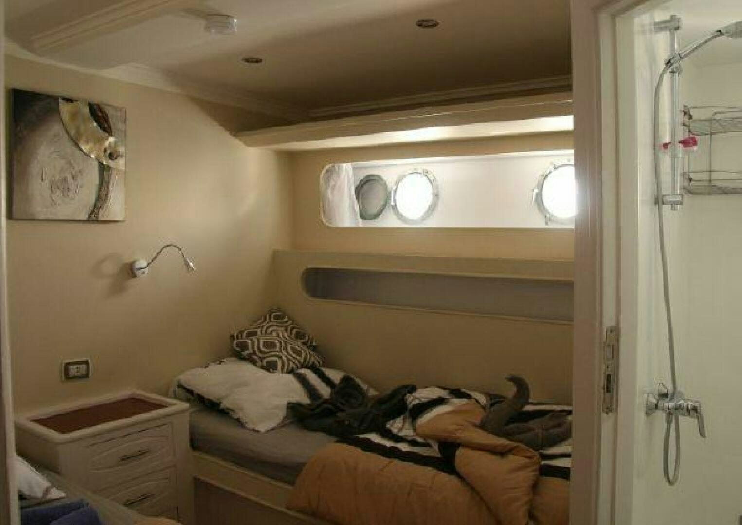a room with a bed and a mirror aboard RED SEA QUEEN Yacht for Sale