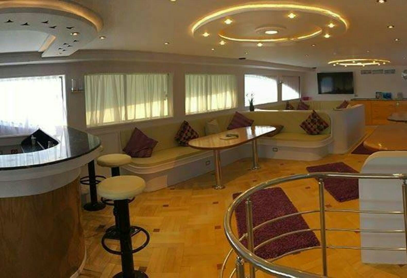 a living room with a couch and a table aboard RED SEA QUEEN Yacht for Sale