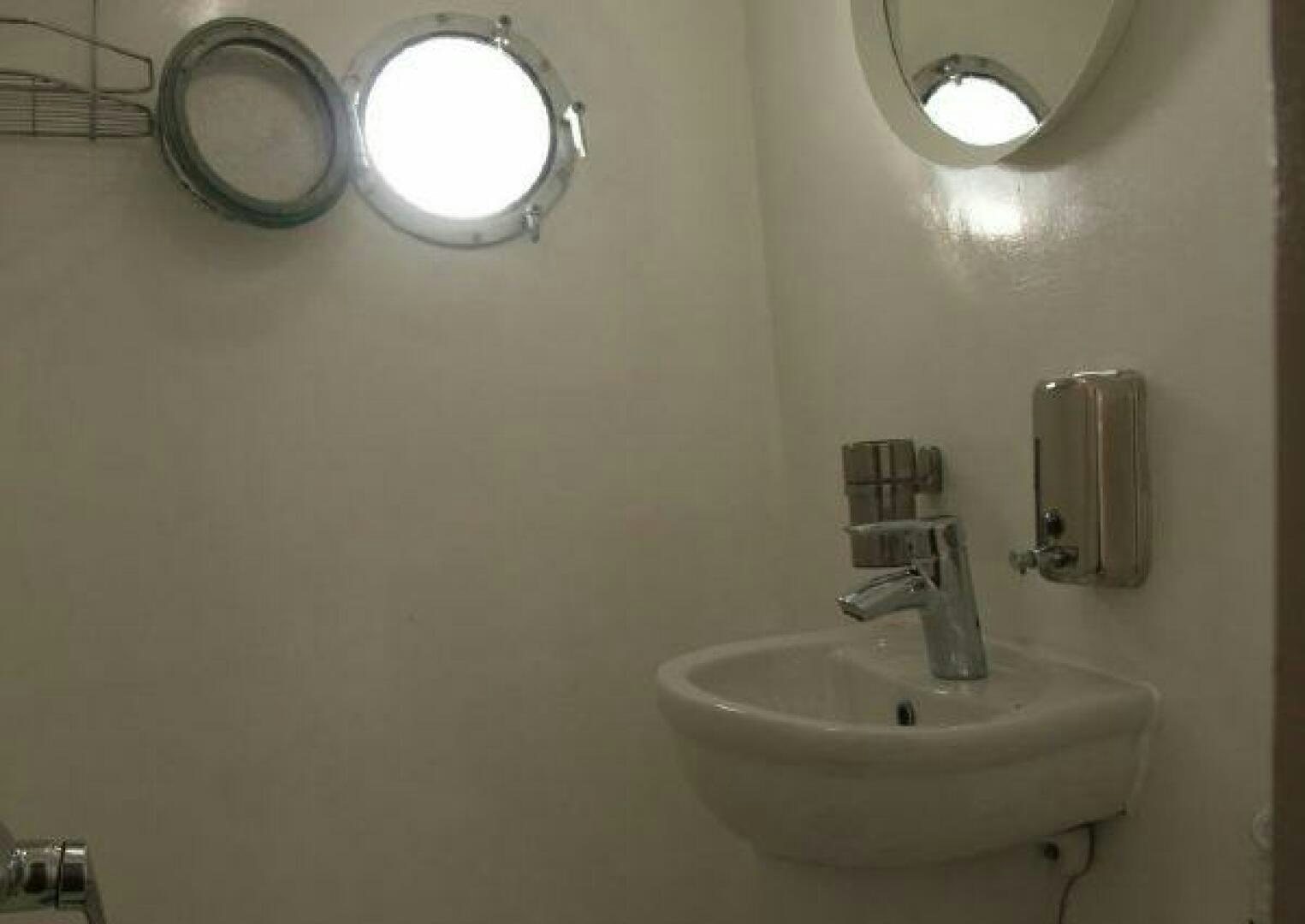 a bathroom with a sink and a mirror aboard RED SEA QUEEN Yacht for Sale