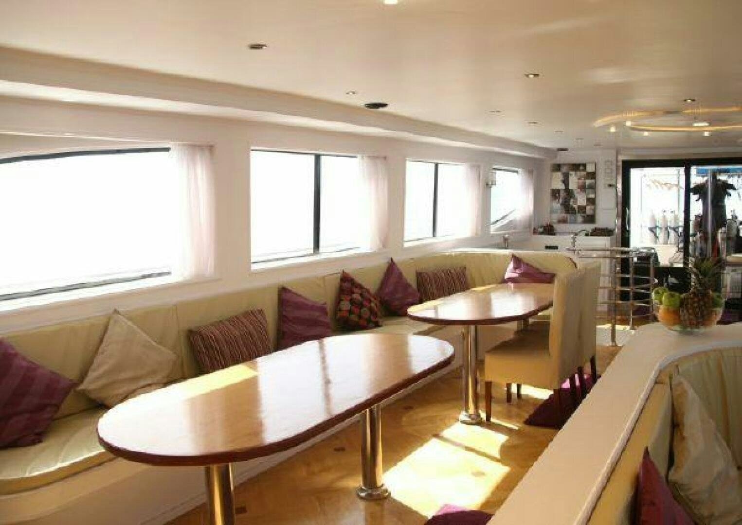 a living room with a table and chairs aboard RED SEA QUEEN Yacht for Sale