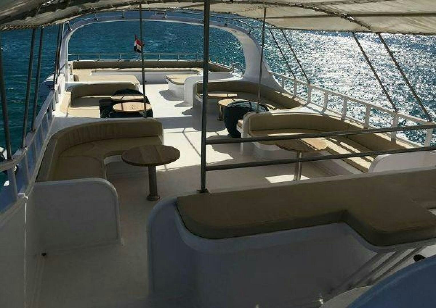 a boat with a deck and chairs aboard RED SEA QUEEN Yacht for Sale