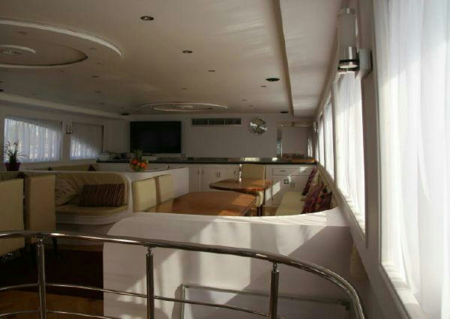 a kitchen with a table and chairs aboard RED SEA QUEEN Yacht for Sale