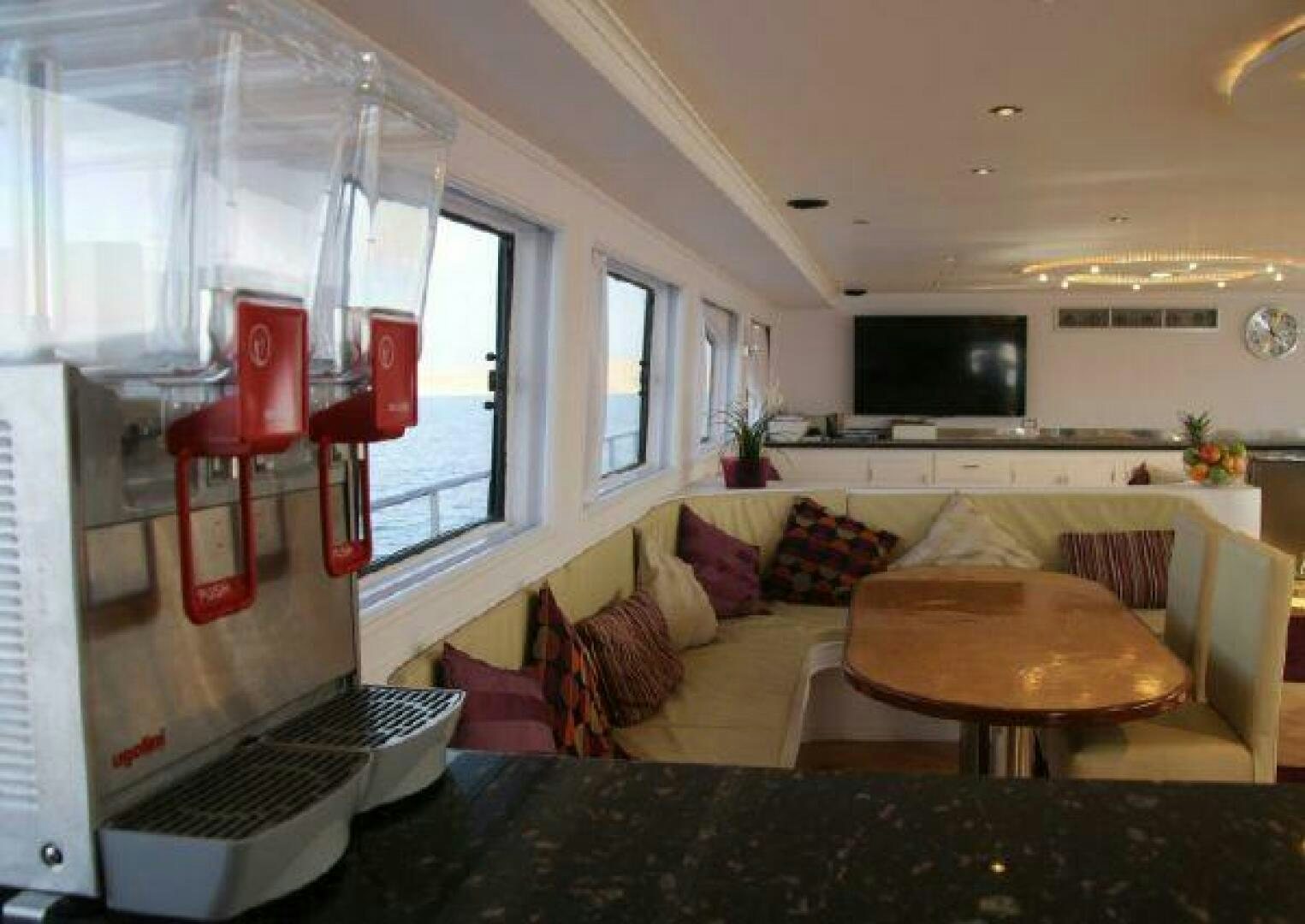 a living room with a couch and a table aboard RED SEA QUEEN Yacht for Sale
