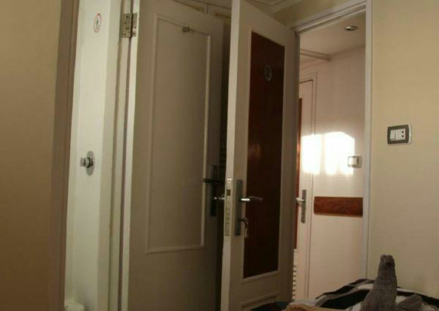 a cat sitting on a counter next to a door aboard RED SEA QUEEN Yacht for Sale