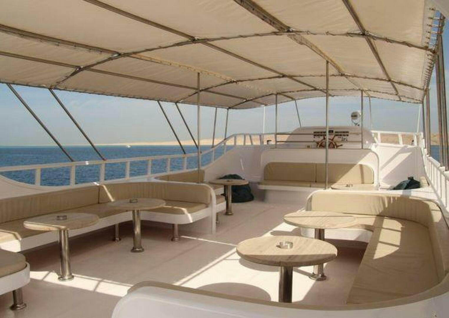 a room with beds and a table aboard RED SEA QUEEN Yacht for Sale