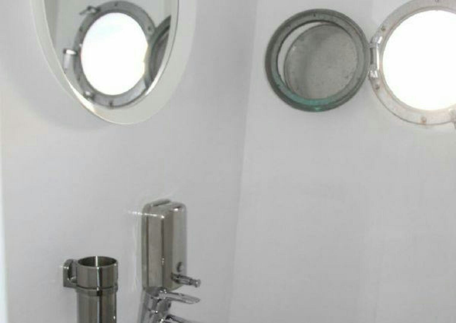 a couple of mirrors on a wall aboard RED SEA QUEEN Yacht for Sale