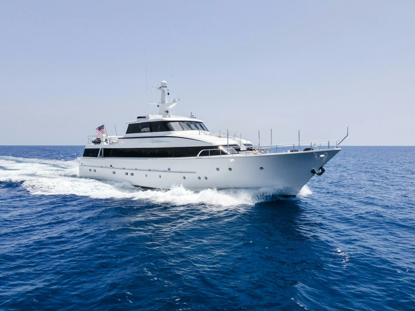 a white yacht on the water aboard ARIES Yacht for Sale