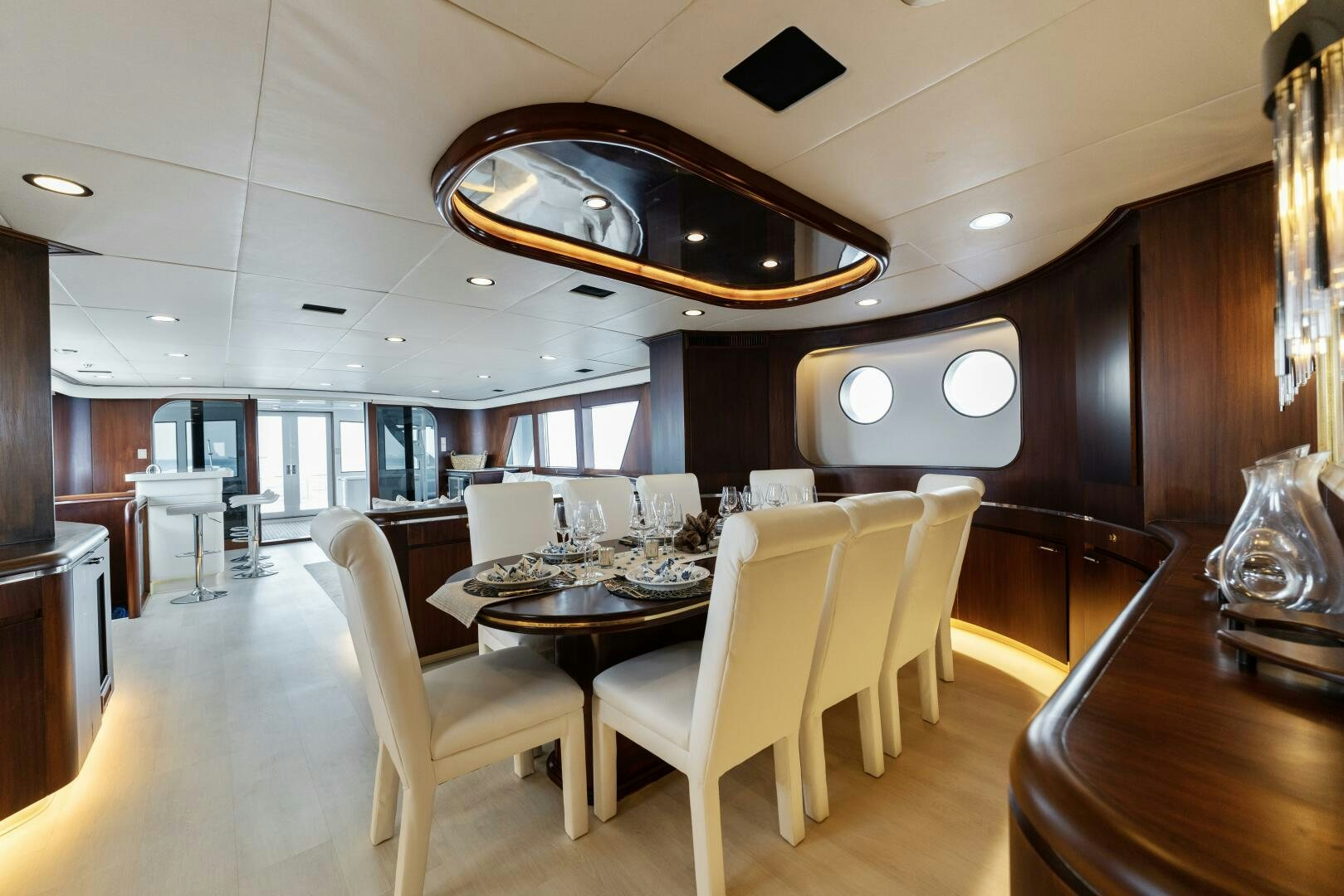 a large room with a table and chairs aboard ARIES Yacht for Sale