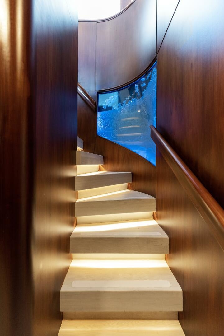 a staircase with a blue sign on it aboard ARIES Yacht for Sale